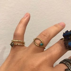 Gold oval ring with round green center stone